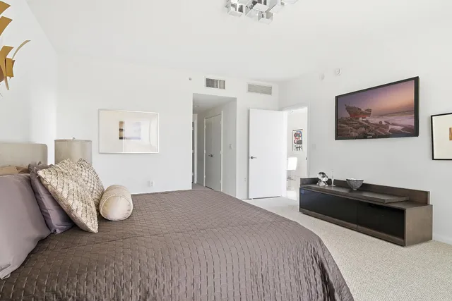 a bedroom with a bed and dresser