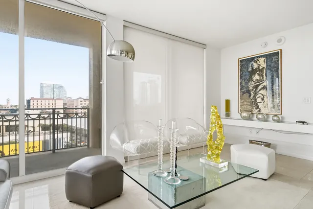 a living room with furniture and a floor to ceiling window