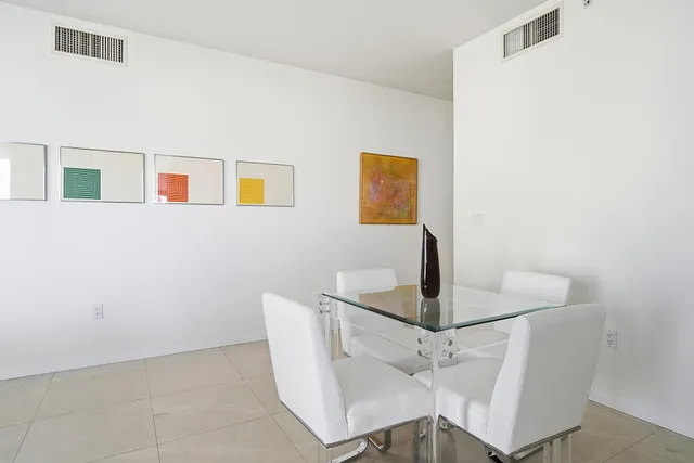 a dining room with table and chairs
