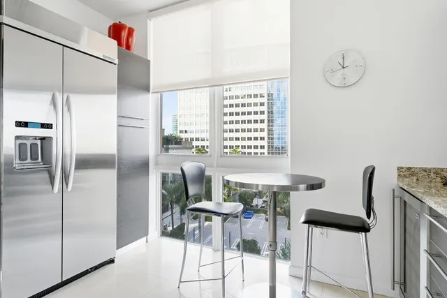 a kitchen with stainless steel appliances granite countertop a refrigerator and a stove top oven