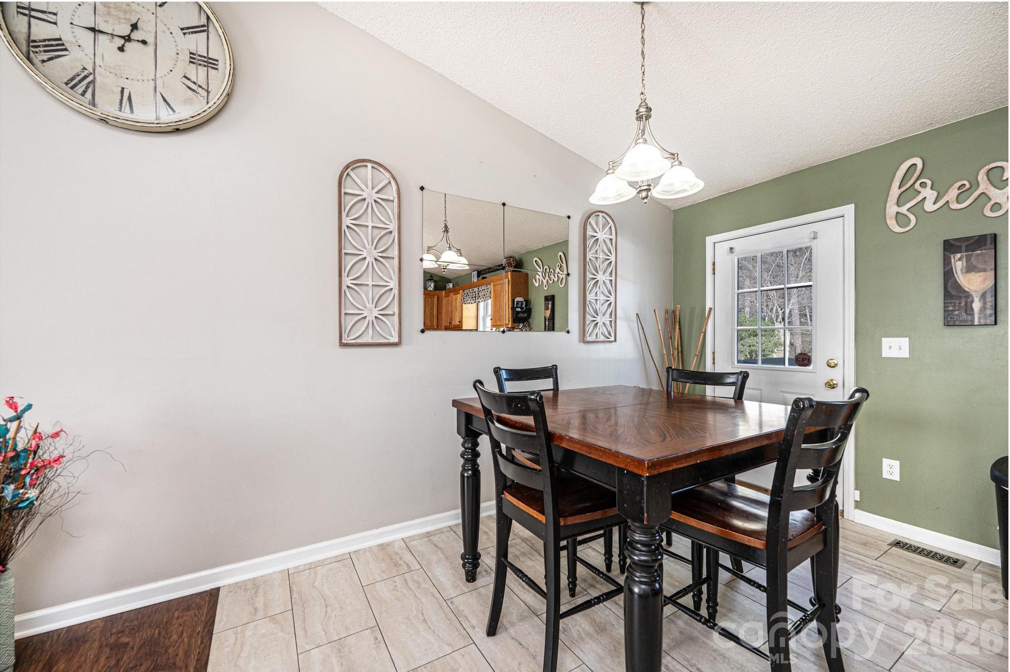 4984 Addison Lane Hickory, NC 28601 - Photo 7 of 32 a view of a dining room with furniture and a chandelier