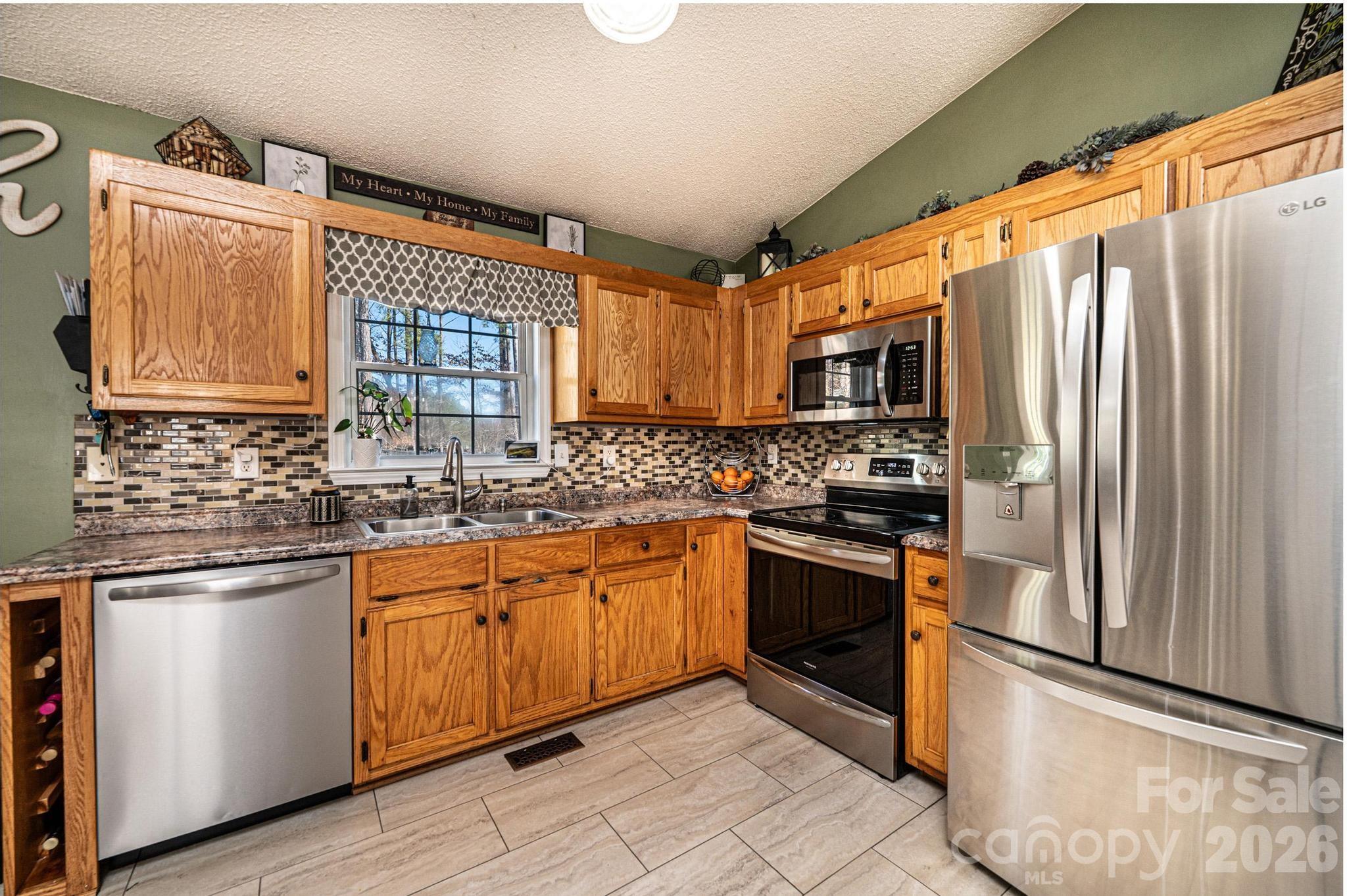 4984 Addison Lane Hickory, NC 28601 - Photo 10 of 32 a kitchen with stainless steel appliances granite countertop a refrigerator sink and microwave