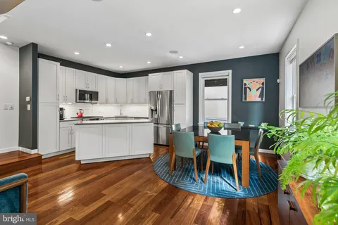 a kitchen with a refrigerator and a dining table