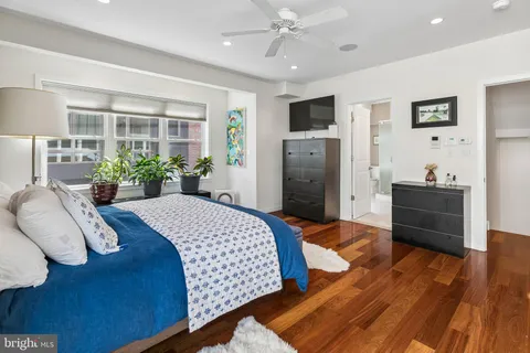 a bed room with a bed dresser and a window