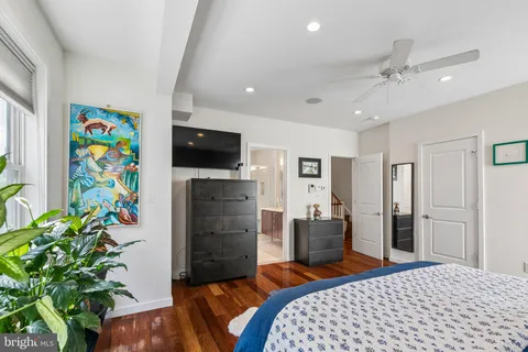 a bedroom with a bed and a potted plant