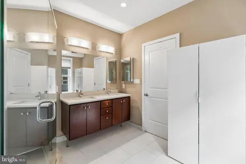 a large bathroom with a granite countertop sink and a mirror