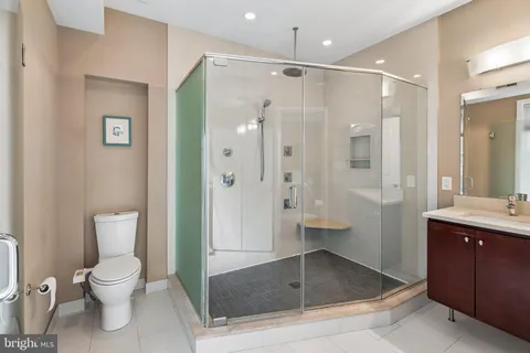 a bathroom with a granite countertop sink toilet and shower
