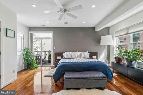 a bedroom with a bed and a potted plant