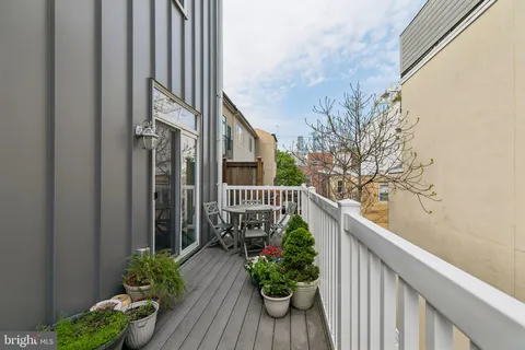 a view of a balcony with flower plants