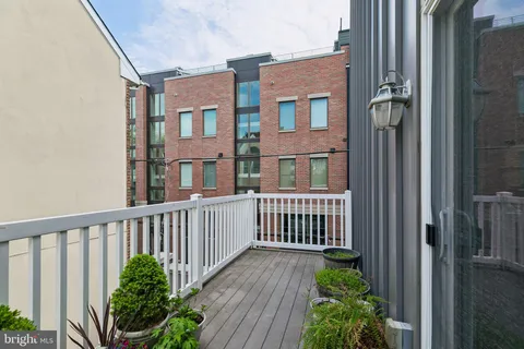 a view of a brick house with a small yard