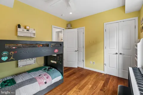 a bedroom with a bed and wooden floor