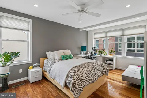 a bedroom with a bed and wooden floor