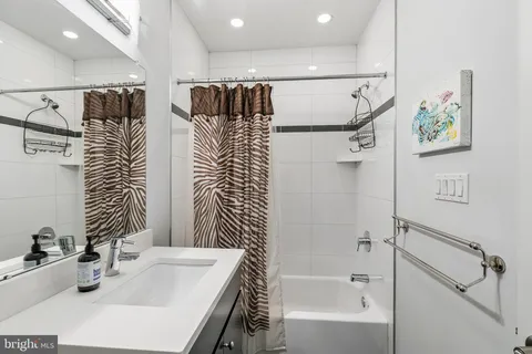 a bathroom with a bathtub and a sink