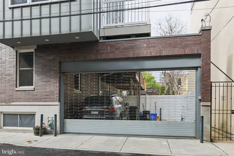 a view of building with car parked