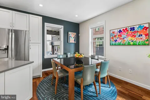 a dining room with furniture and wooden floor