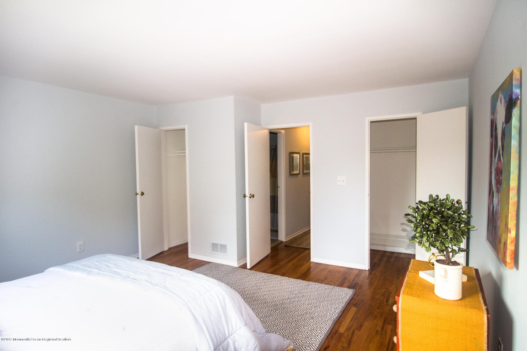 321 Spring Street, Unit 7 Red Bank, NJ 07701 - Photo 11 of 17 a bedroom with a bed and a potted plant