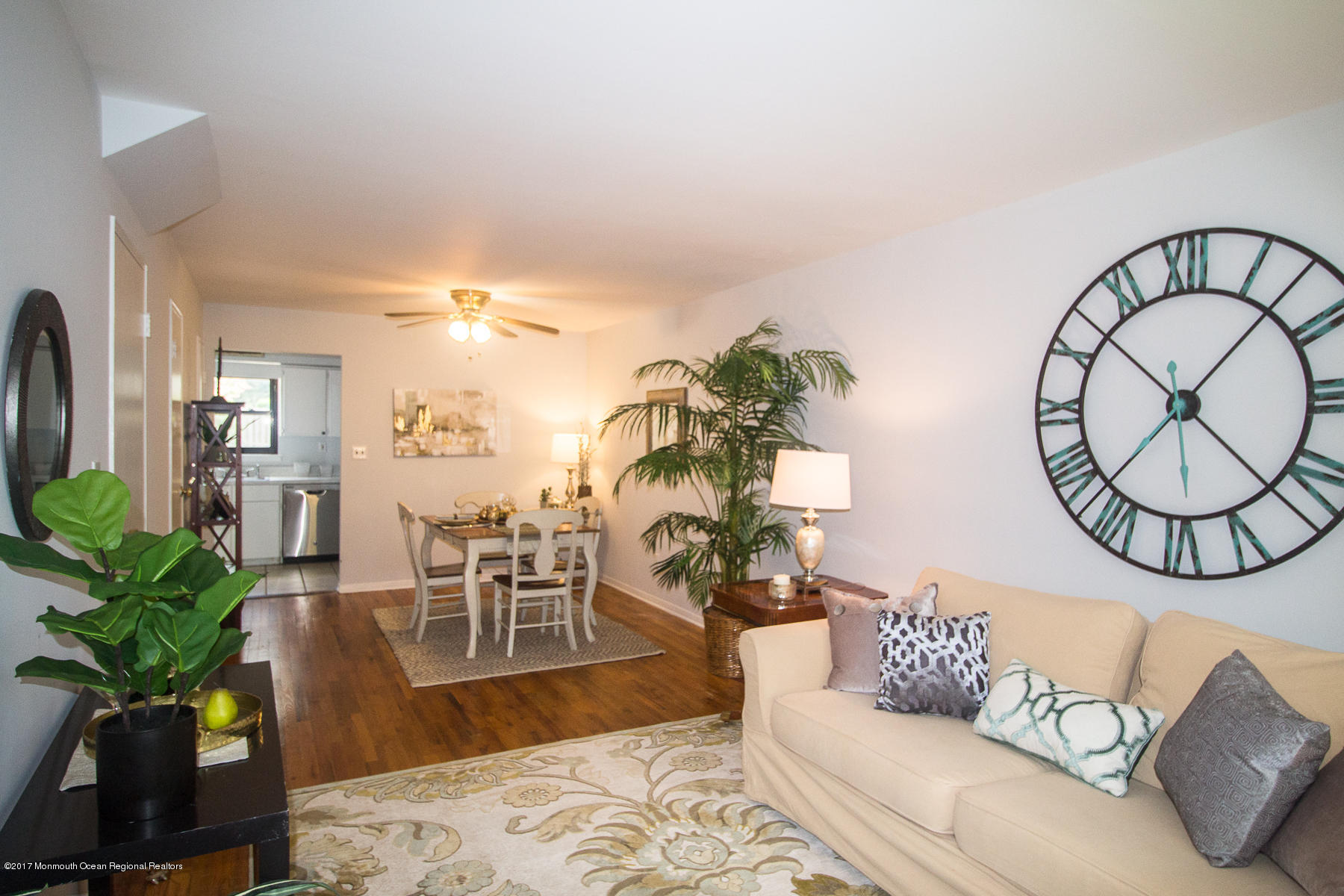 321 Spring Street, Unit 7 Red Bank, NJ 07701 - Photo 4 of 17 a living room with furniture a chandelier and a potted plant