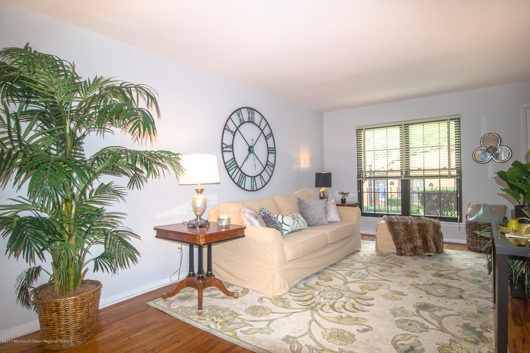 321 Spring Street, Unit 7 Red Bank, NJ 07701 - Photo 5 of 17 a living room with furniture a chandelier and a large window