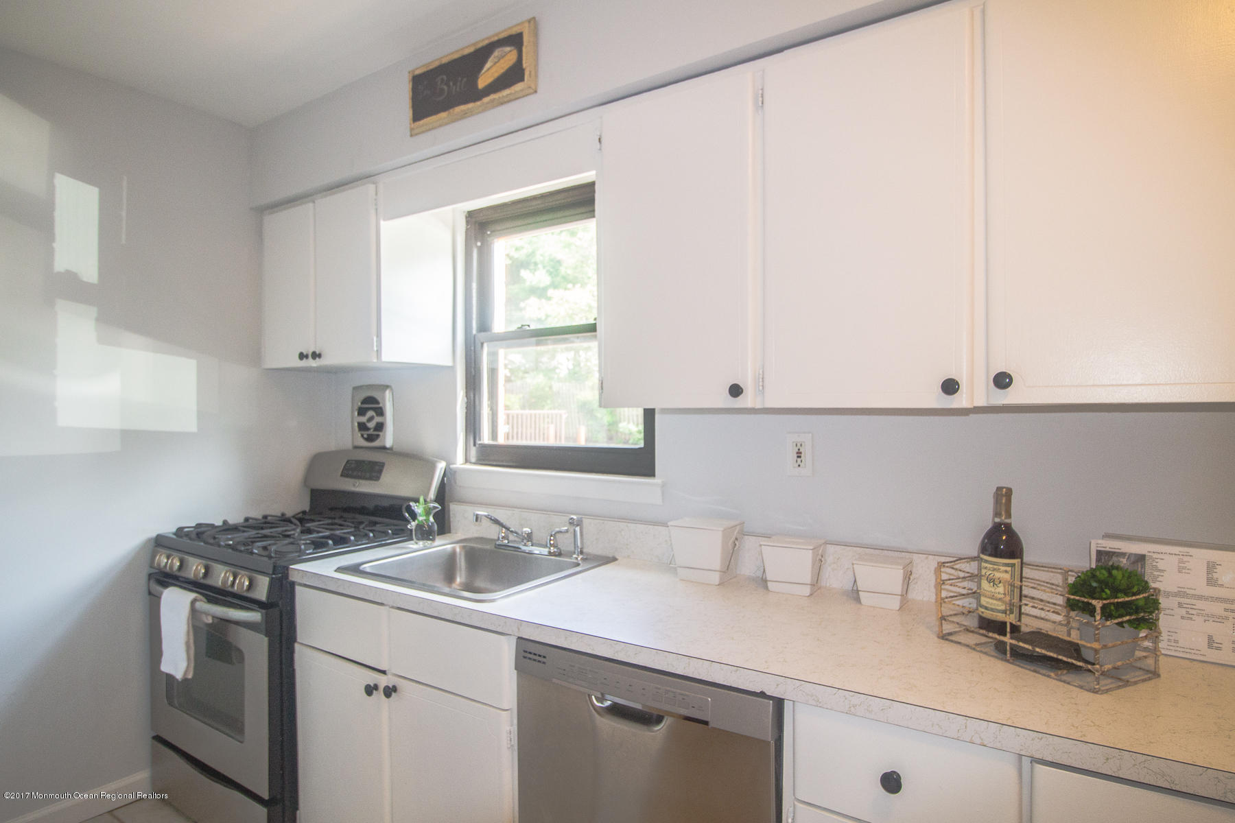 321 Spring Street, Unit 7 Red Bank, NJ 07701 - Photo 9 of 17 a kitchen with a sink and cabinets