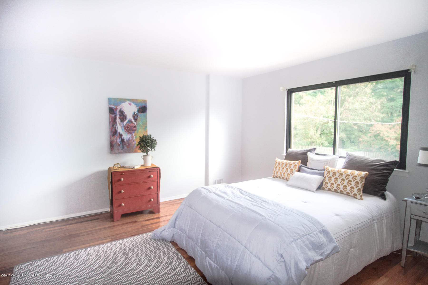 321 Spring Street, Unit 7 Red Bank, NJ 07701 - Photo 10 of 17 a bedroom with a bed and a window