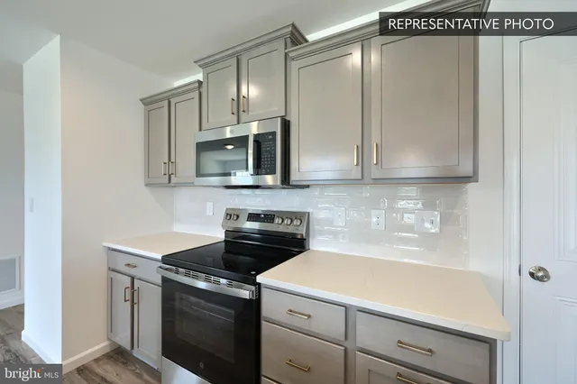a kitchen with stainless steel appliances white cabinets and a stove