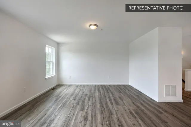 a view of a room with wooden floor and window