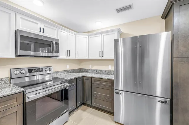 a view of an empty room with a fireplace and a window