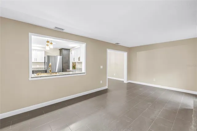 an empty room with a fireplace and window