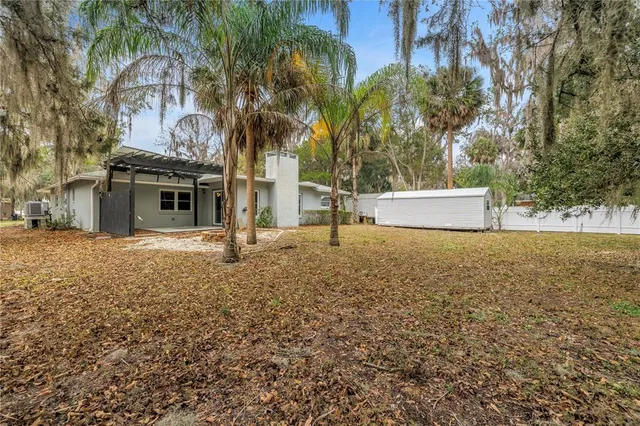 a view of dirt yard with a fountain