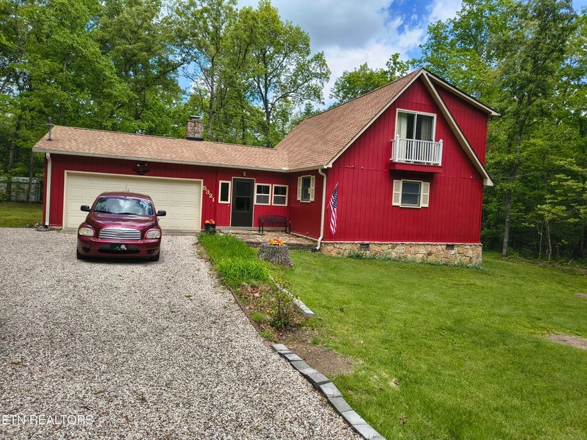 5321 Pawnee Road Crossville, TN 38572 - Photo 1 of 11 a front view of a house with a yard