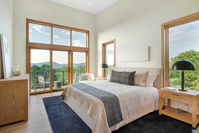 a bedroom with a large bed and a large window