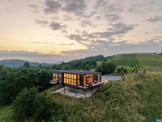 an aerial view of a house and mountain view