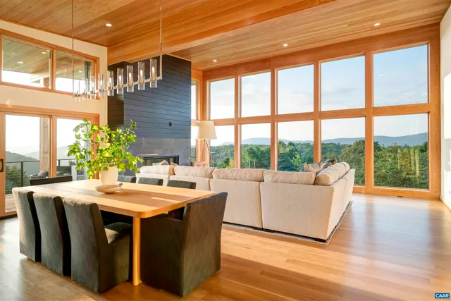 a living room with dining table and a large window