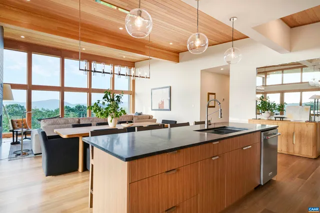 a kitchen with a sink and large windows