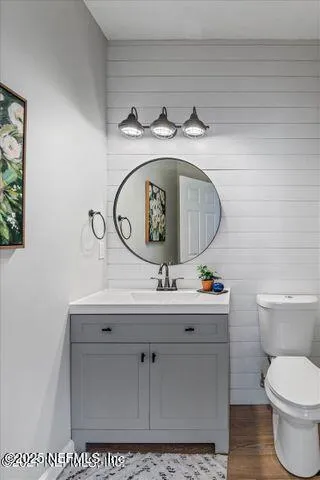 a bathroom with a toilet a sink and a mirror