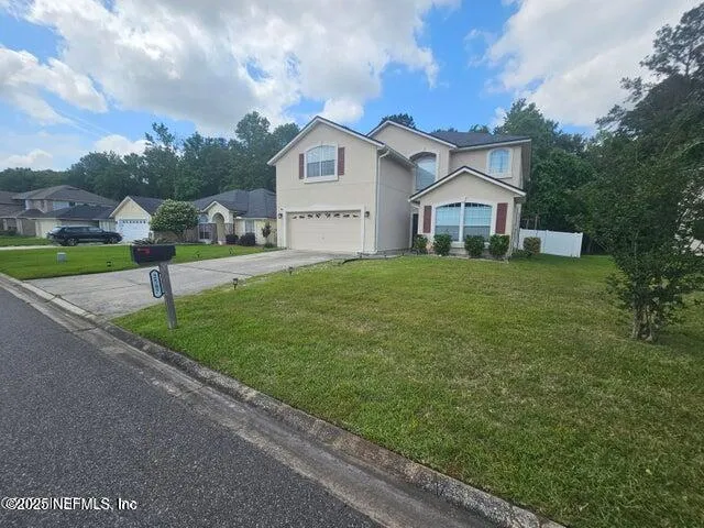 a view of a big house with a big yard and potted plants