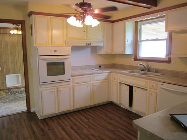 228 Copeland Road Clarksville, TN 37042 - Photo 3 of 12 a kitchen with a sink cabinets stainless steel appliances and a chandelier