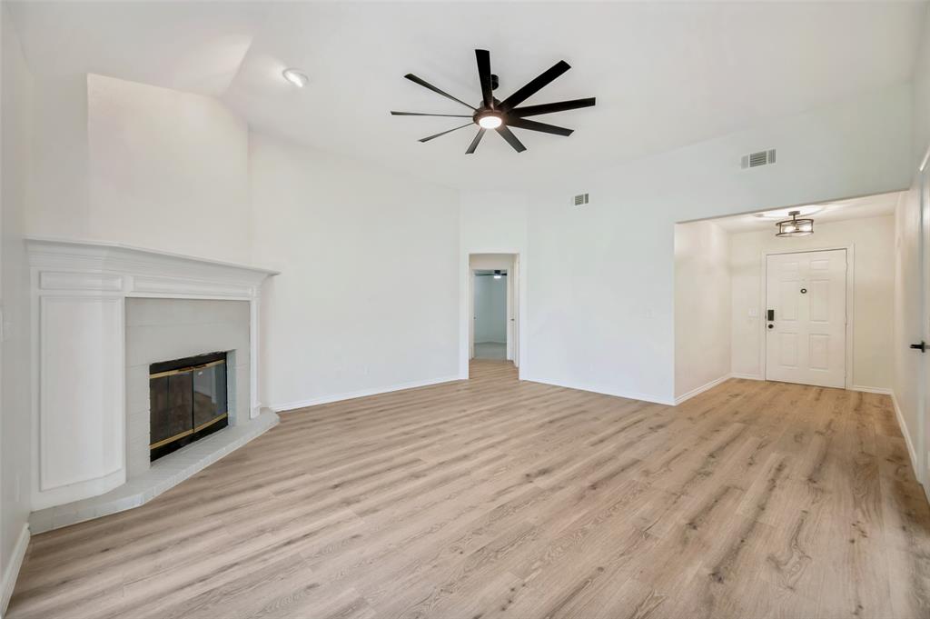 629 Concho Drive Oak Point, TX 75068 - Photo 7 of 35 a view of a livingroom with a ceiling fan a fireplace and a ceiling fan