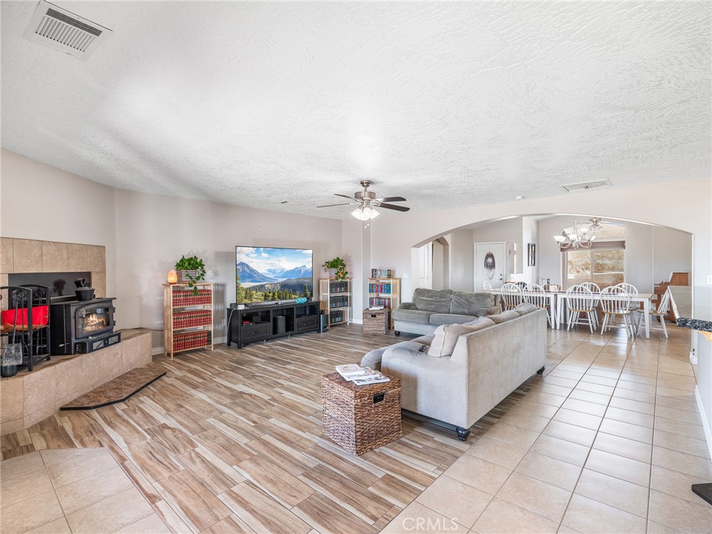13850 Night Shade Road Apple Valley, CA 92307 - Photo 11 of 75 a living room with furniture a flat screen tv and a fireplace