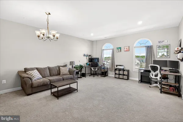 a living room with furniture and a chandelier