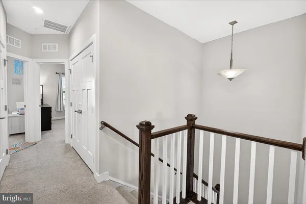 a view of a hallway with a chandelier