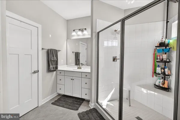 a spacious bathroom with a shower and a sink