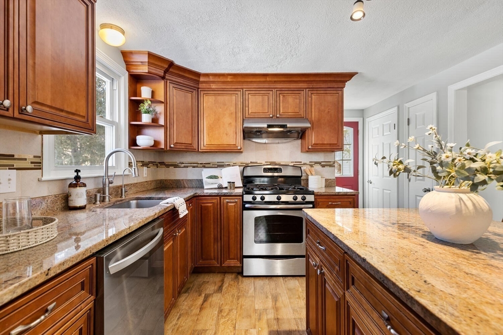 72 Grassland Street Lexington, MA 02421 - Photo 11 of 37 a kitchen with stainless steel appliances granite countertop a stove a sink and a refrigerator