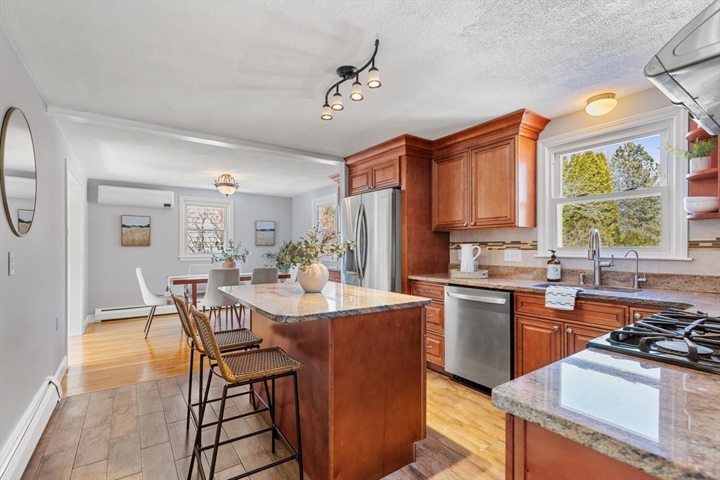 72 Grassland Street Lexington, MA 02421 - Photo 13 of 37 a kitchen with a stove a sink a dining table and chairs