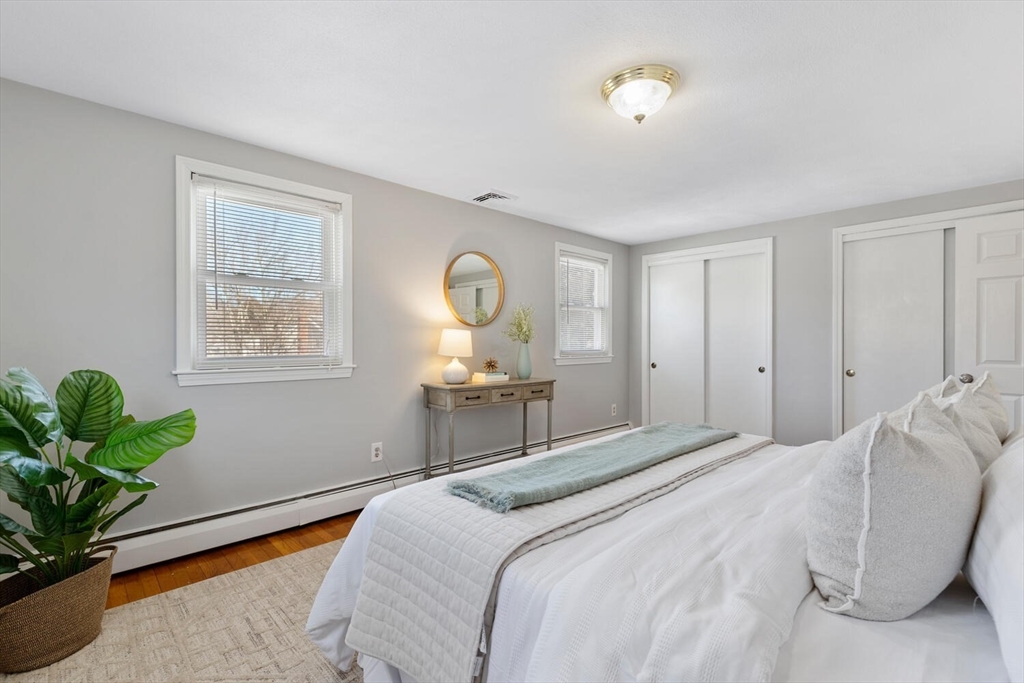 72 Grassland Street Lexington, MA 02421 - Photo 20 of 37 a bedroom with a bed and a potted plant