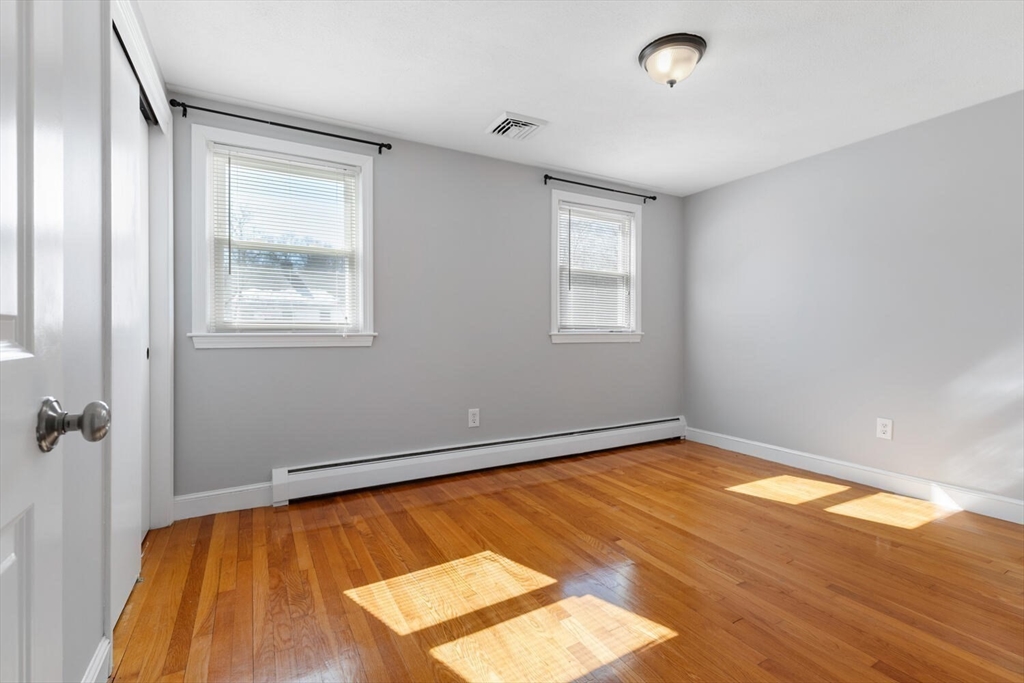 72 Grassland Street Lexington, MA 02421 - Photo 21 of 37 a view of an empty room with wooden floor and a window
