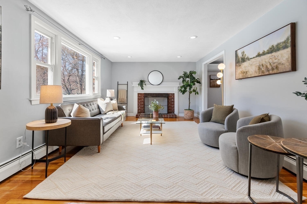72 Grassland Street Lexington, MA 02421 - Photo 3 of 37 a living room with furniture and a fireplace