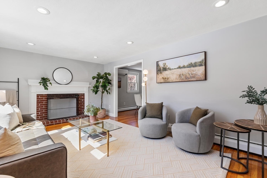 72 Grassland Street Lexington, MA 02421 - Photo 5 of 37 a living room with furniture and a fireplace