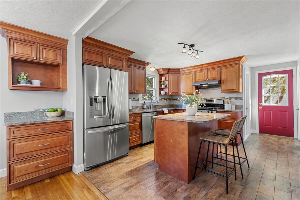72 Grassland Street Lexington, MA 02421 - Photo 10 of 37 a kitchen with stainless steel appliances granite countertop a refrigerator a stove a sink and dishwasher