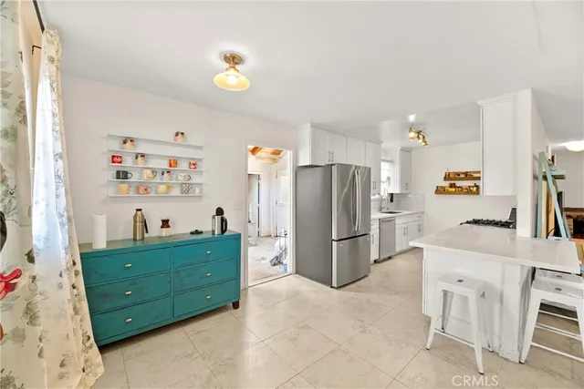 a kitchen with stainless steel appliances a refrigerator and a stove